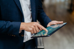 Asian businessman checking stock market chart on digital tablet